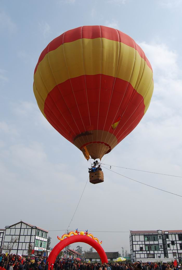 热气球成为本届菜花节上一大亮点。图为游客搭载升空的热气球。（记者 罗 成 摄）.jpg
